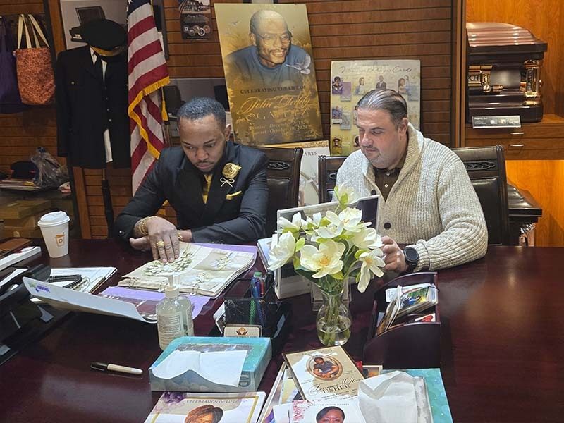 Funeral director explaining funeral payment plans and arrangements to a family in Brooklyn