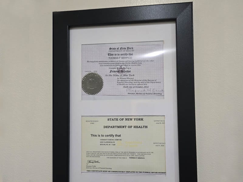 New York State Department of Health funeral director licenses displayed inside Harmony Funeral Home.