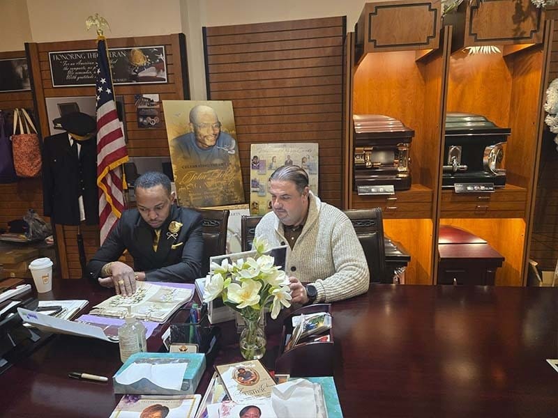 Funeral director coordinating a respectful pre-arranged funeral transfer service