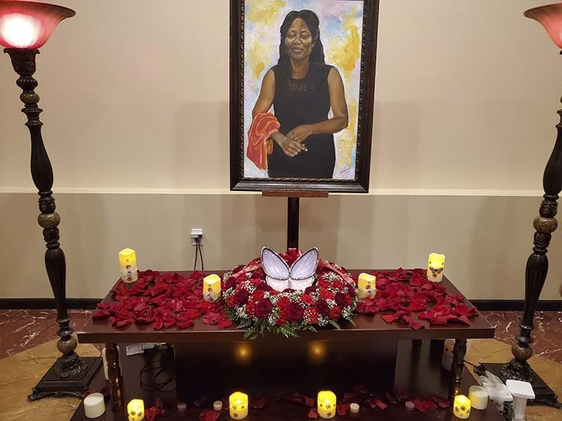 Memorial portrait display with candles and flowers honoring a loved one at Harmony Funeral Home in Brooklyn NY