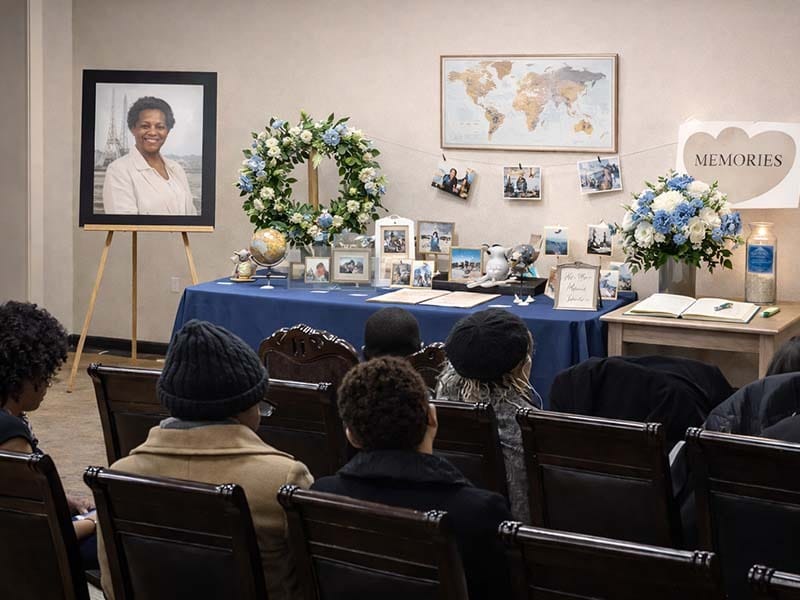 Personalized celebration of life display with photographs and candles during a non-religious funeral in Brooklyn